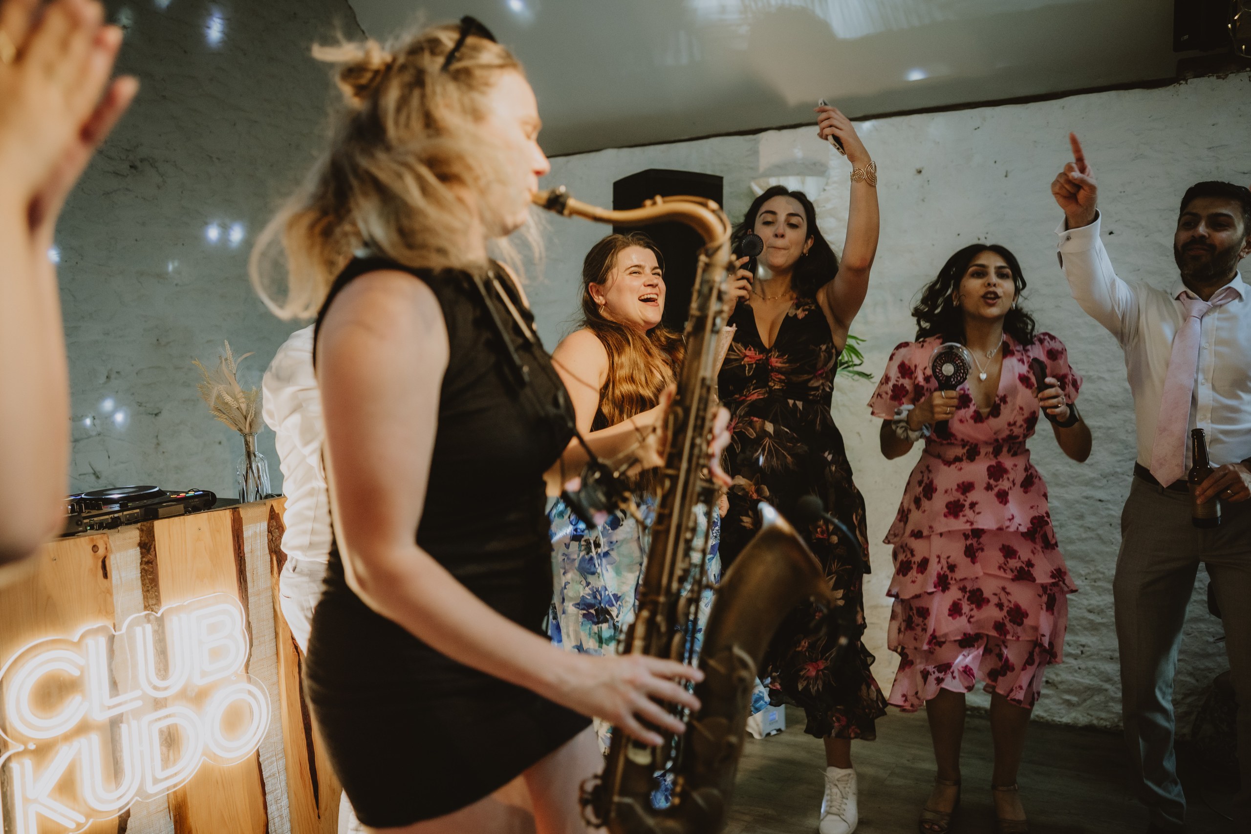 Club Kudo sax player performing among wedding guests at Stratton Court Barn