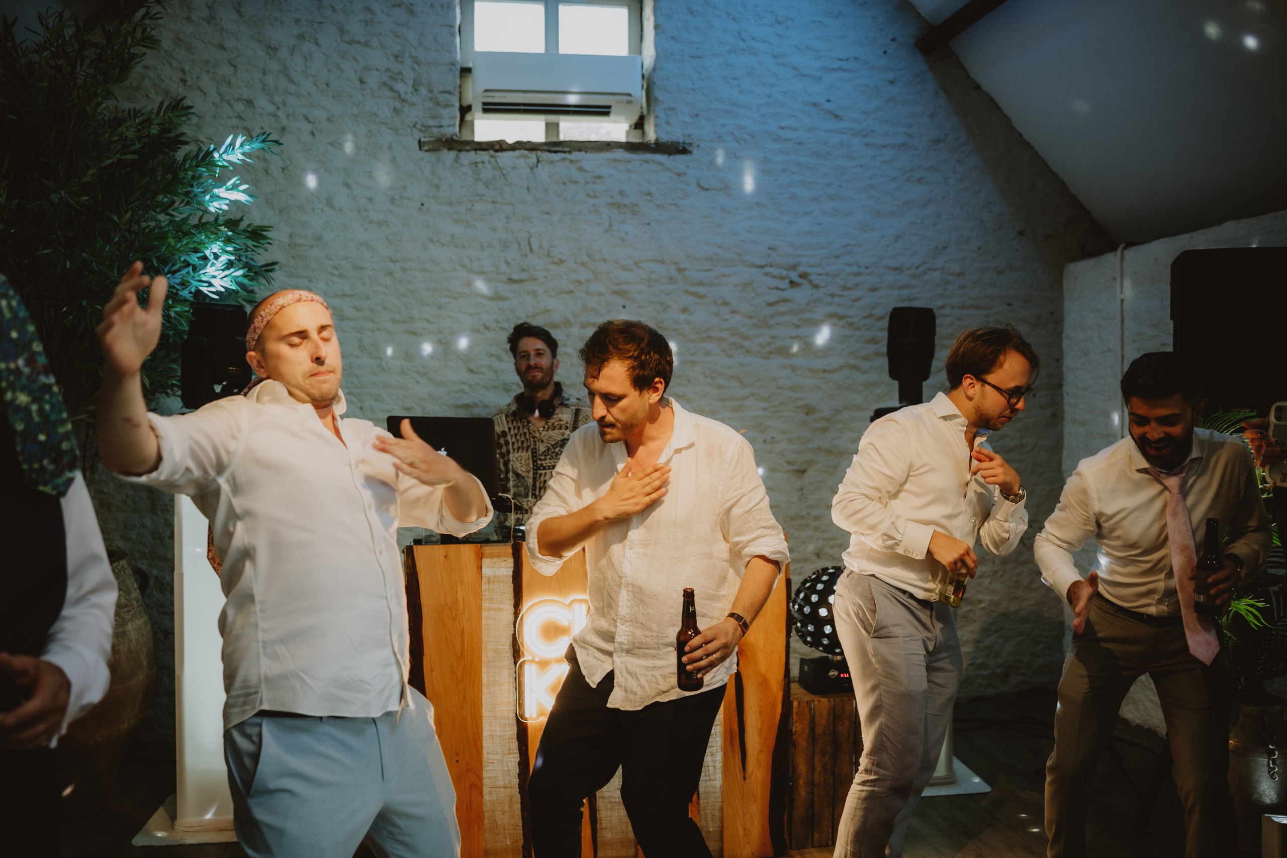 Wedding guests dancing in front of the Club Kudo booth at Stratton Court Barn